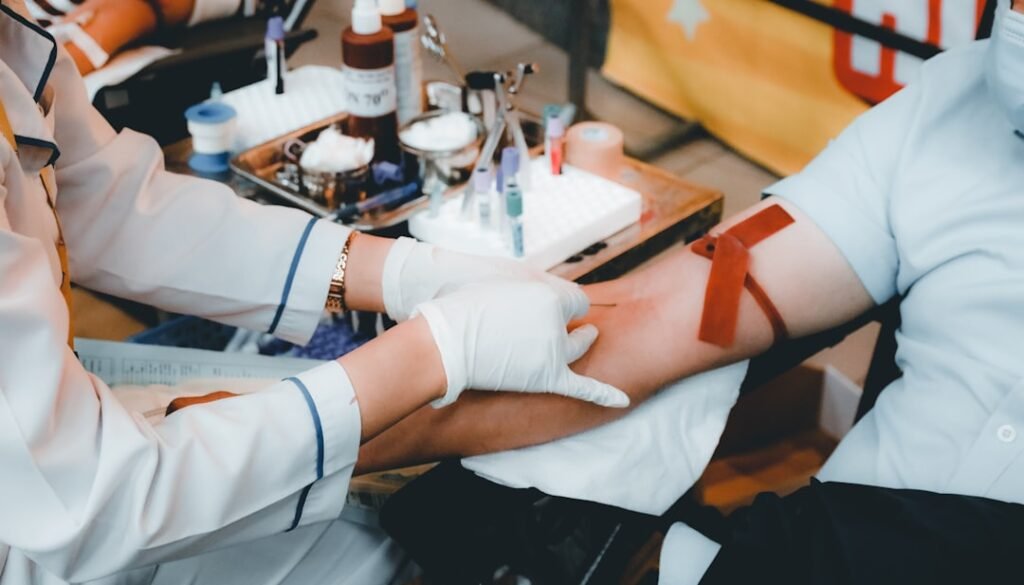 Healthcare professional drawing blood to evaluate possible causes of low testosterone